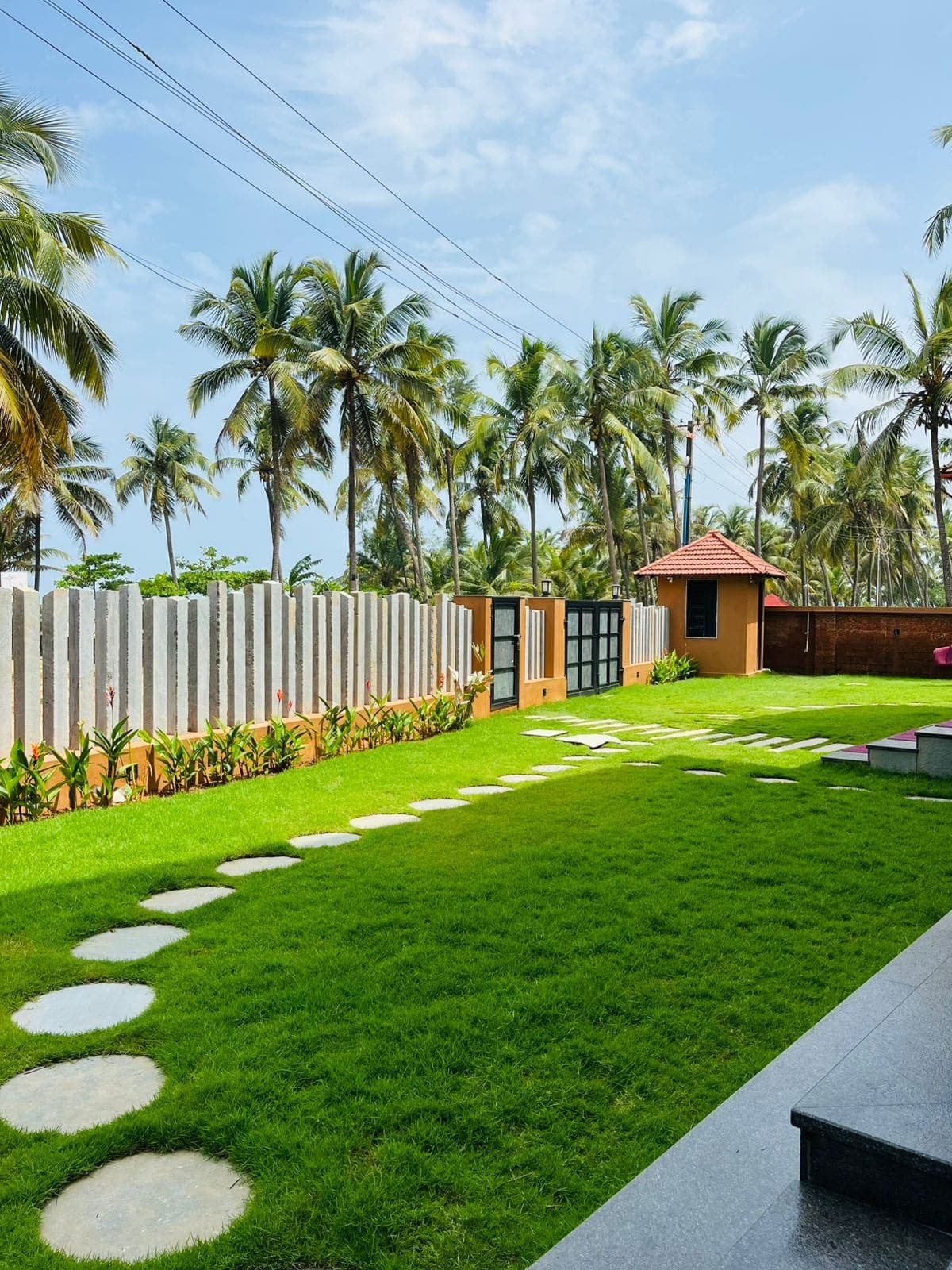 The lawn and garden just outside the ground-floor rooms, with stepping stones set into the grass