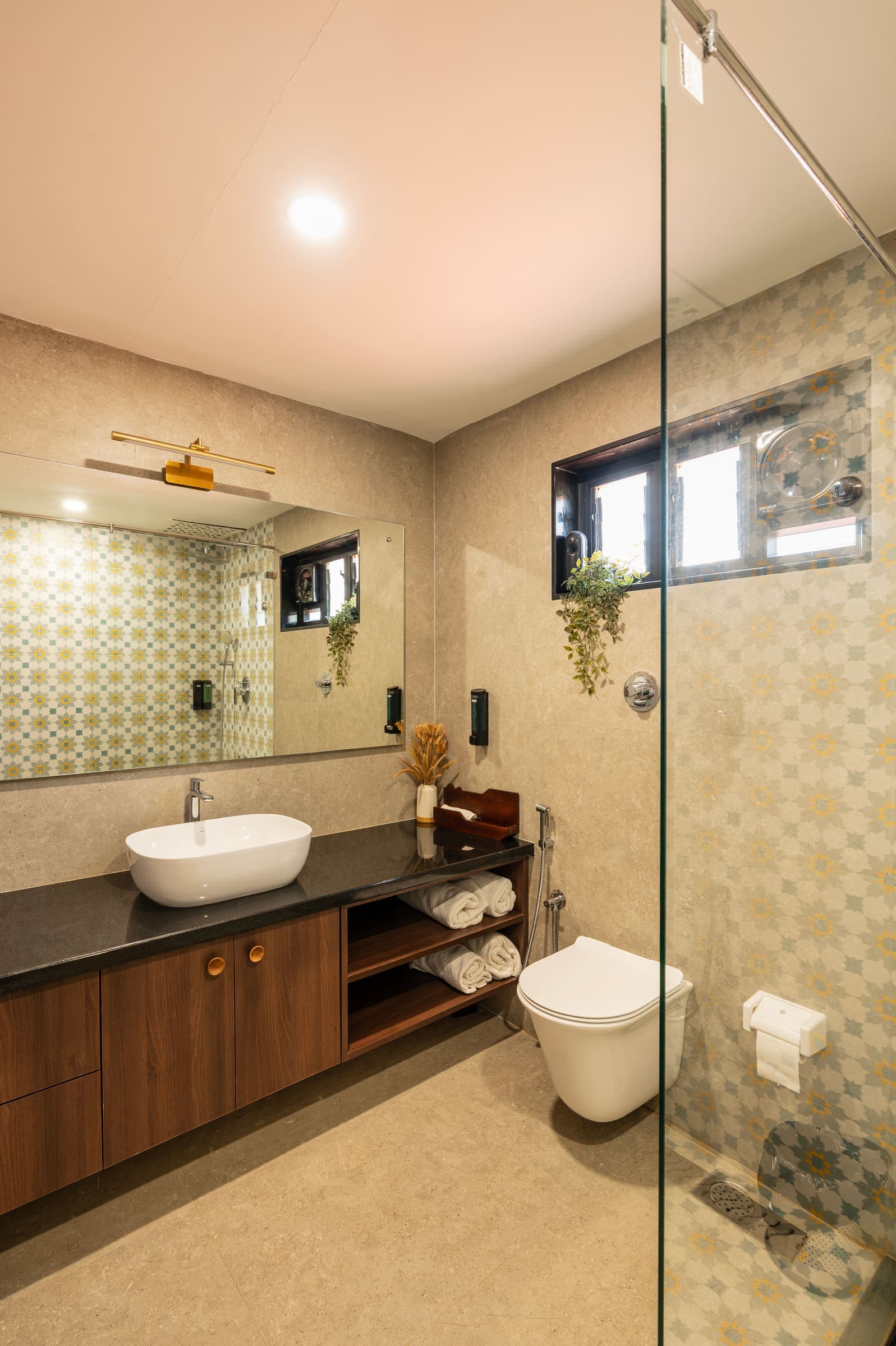 The Varahi bathroom vanity, with its vessel basin, patterned tile and lit mirror