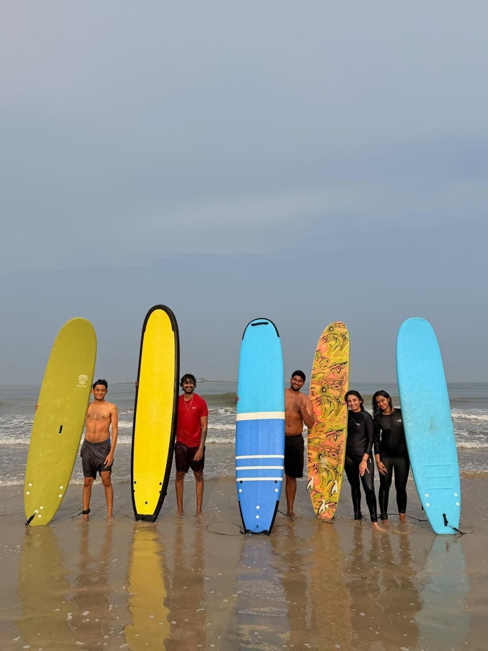 A surfer riding a wave off the Udupi coast