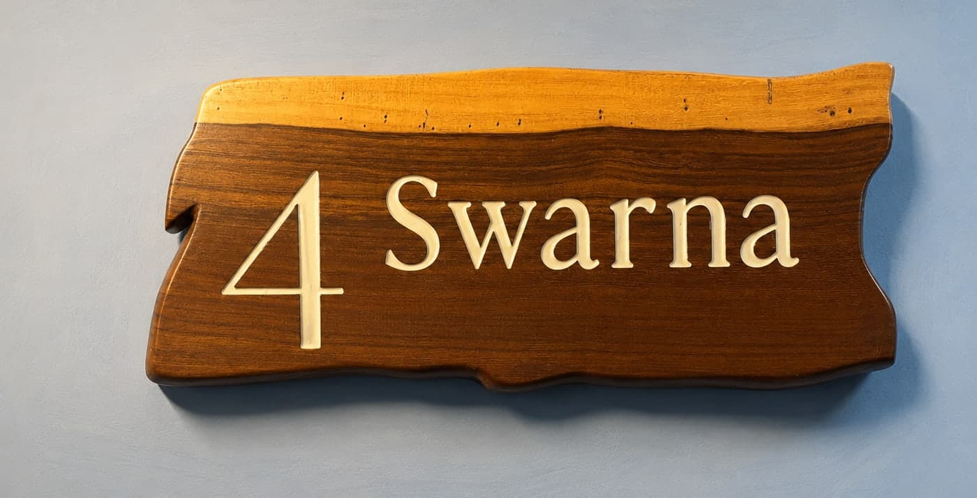 The hand-carved live-edge nameplate for Swarna, room 4